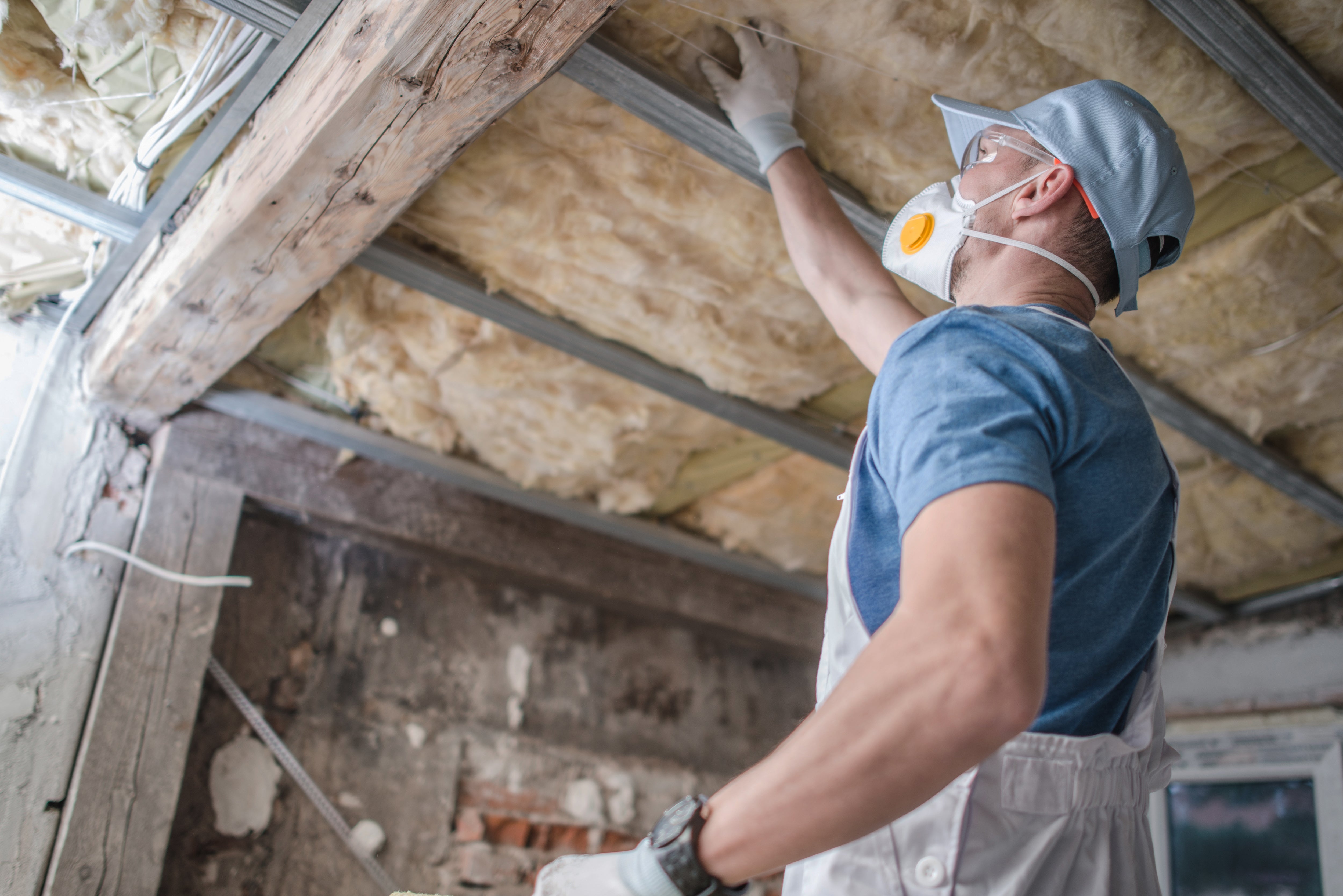 man checking his attic's insulation