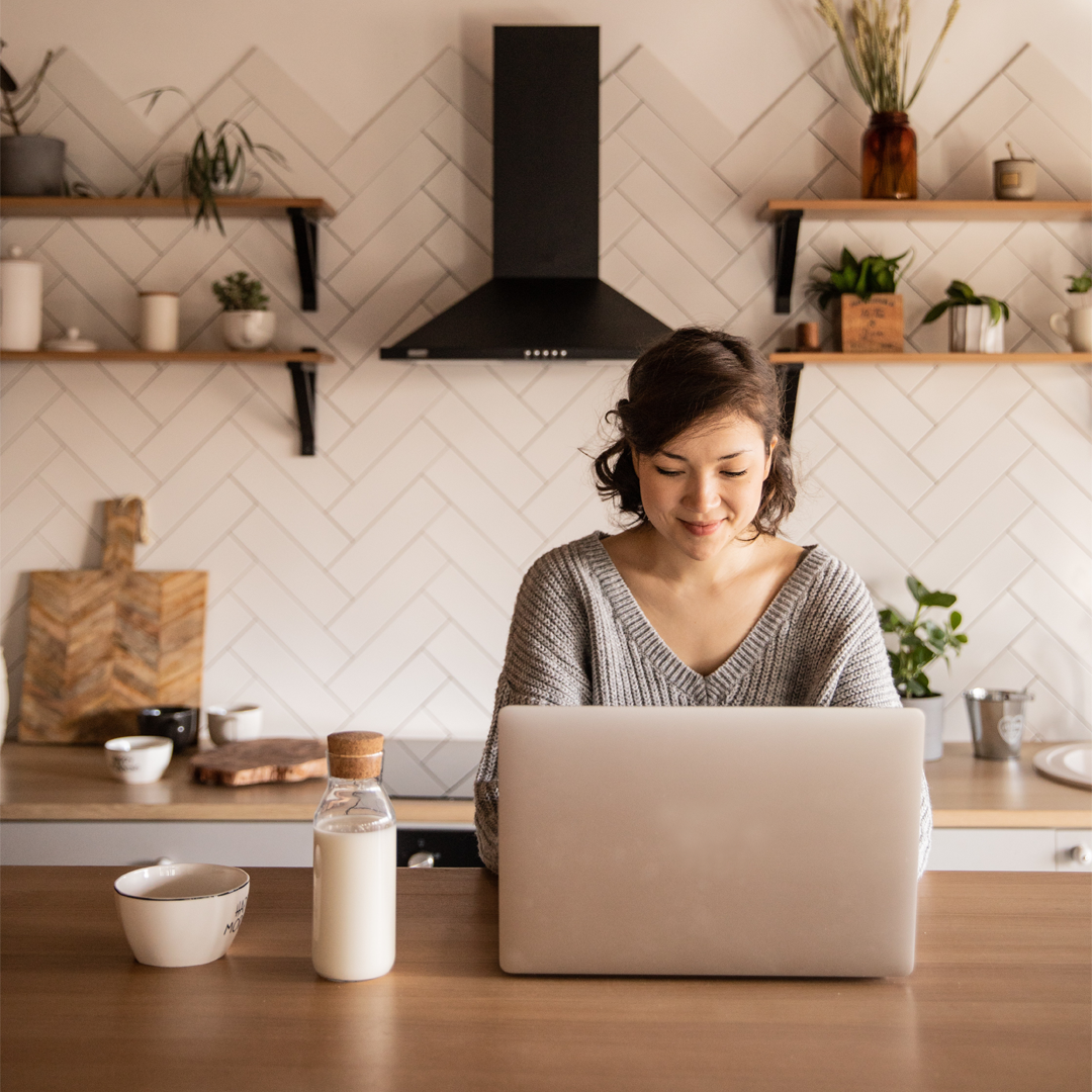 woman with laptop in kitchen
