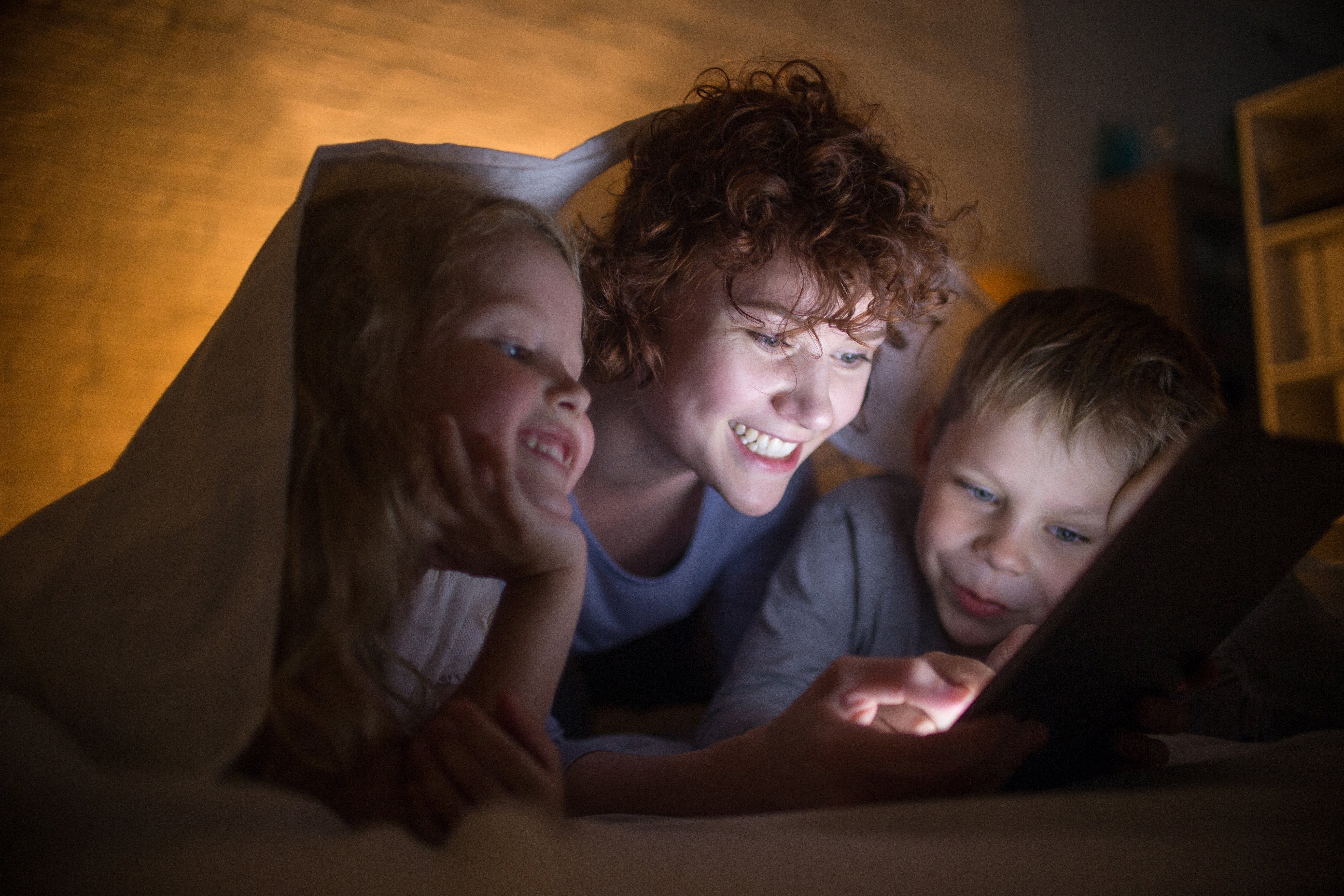 mother reading with children during power outage