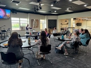 A group listens to a presentation at a recent TMOAA meeting.