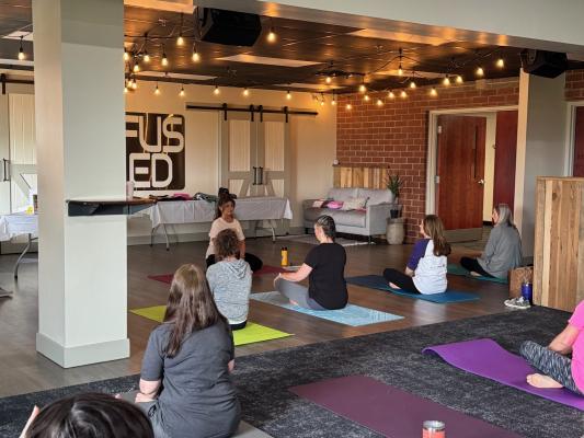 A group of women participate in yoga at a recent TMOAA retreat.