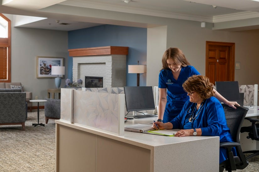 Stillwater Hospice employees review patient information in the office.