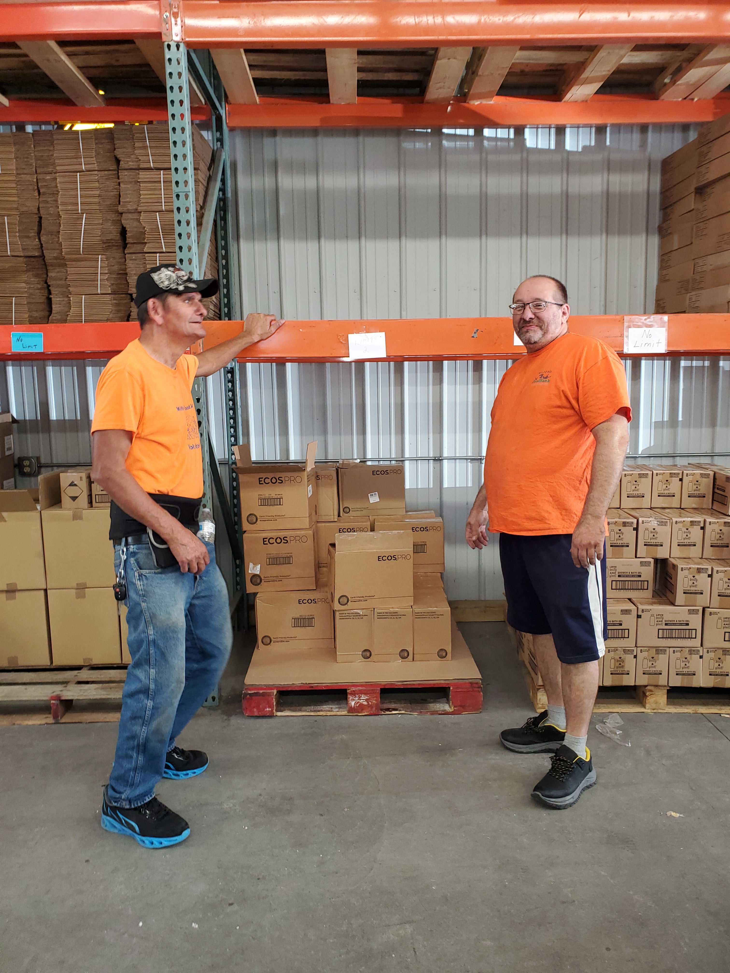 Two Milford Food Bank volunteers take a break to pose for a photograph