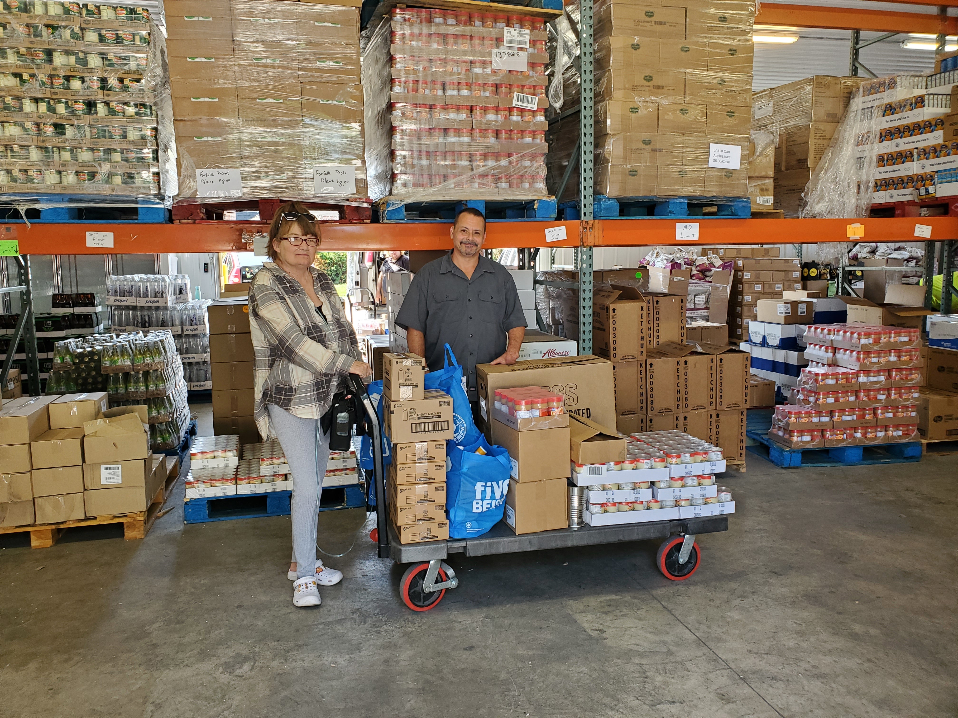 Two Milford Food Bank partners load up food to distribute in their community