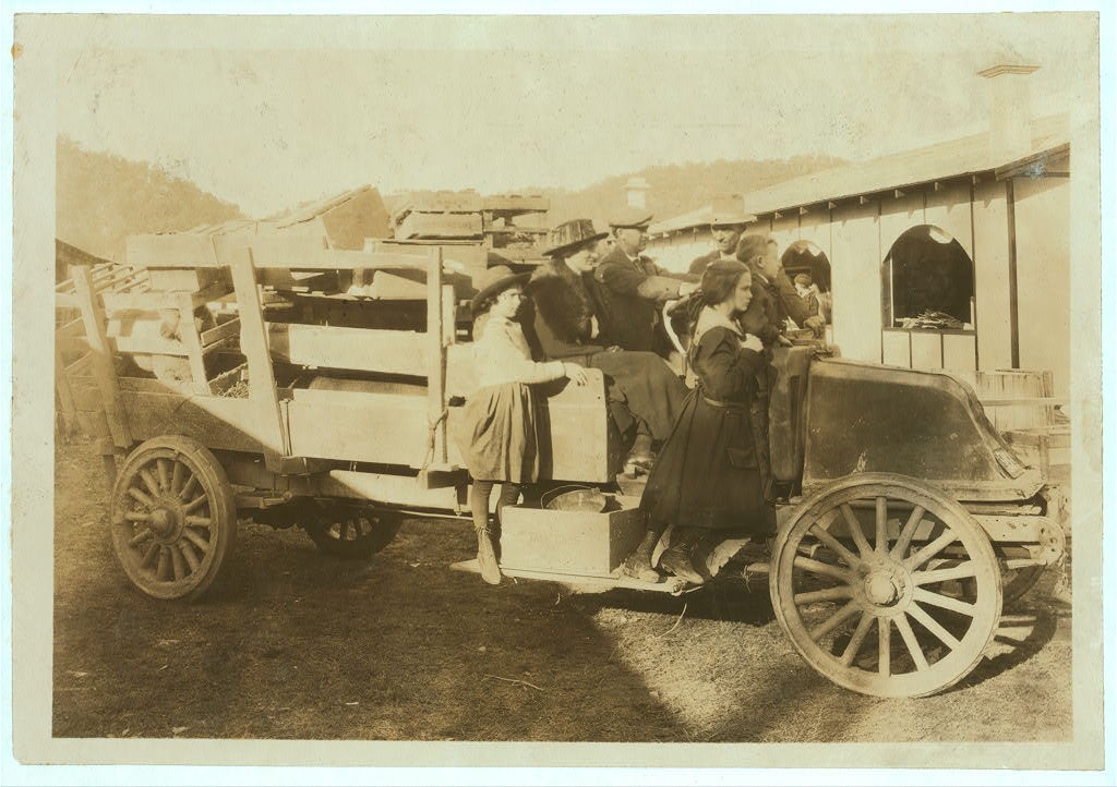 A family drives a truck onto the fairgrounds in the early 1900's.