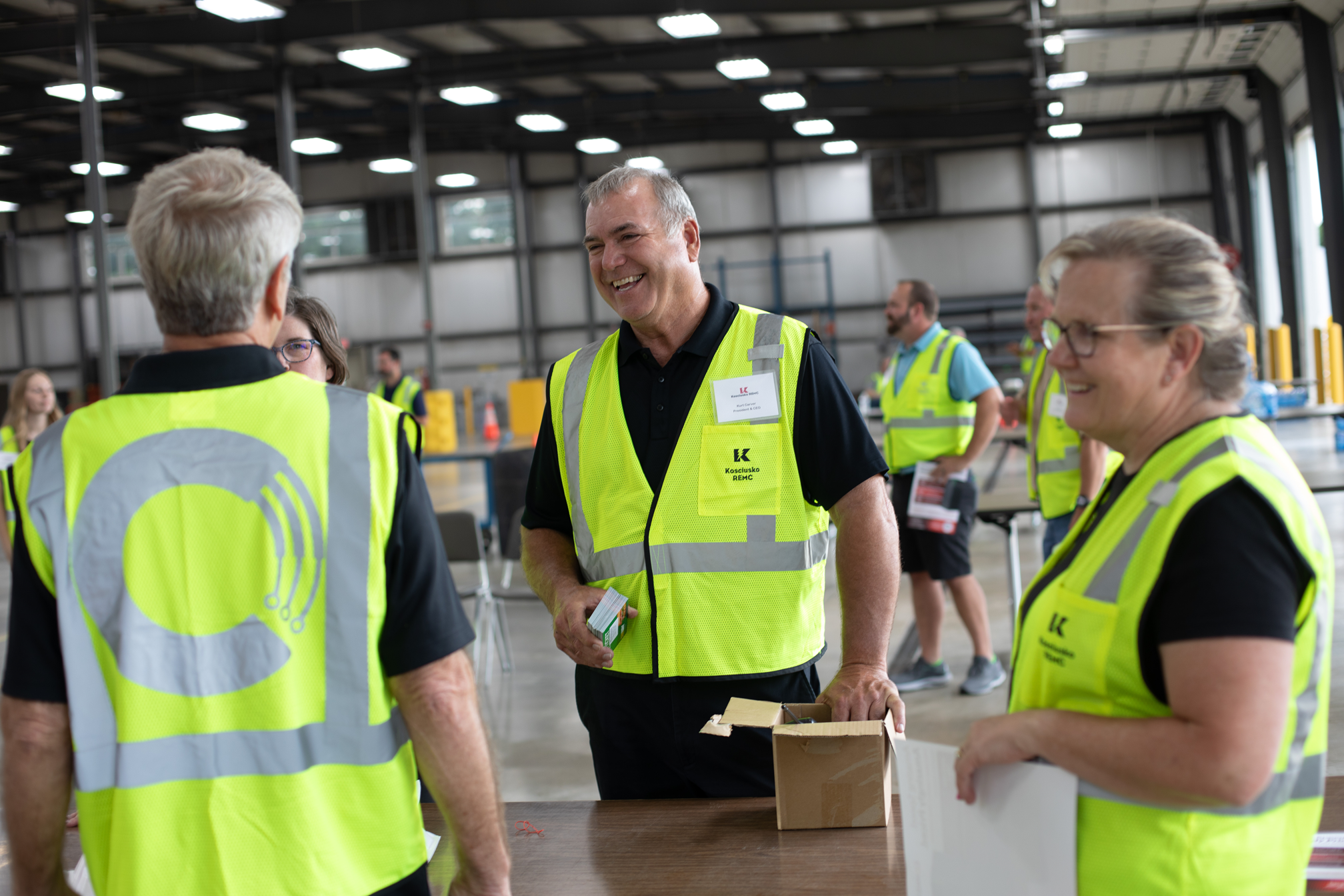 KREMC CEO Kurt Carver speaks with board members and candidates at the drive-through annual meeting. 