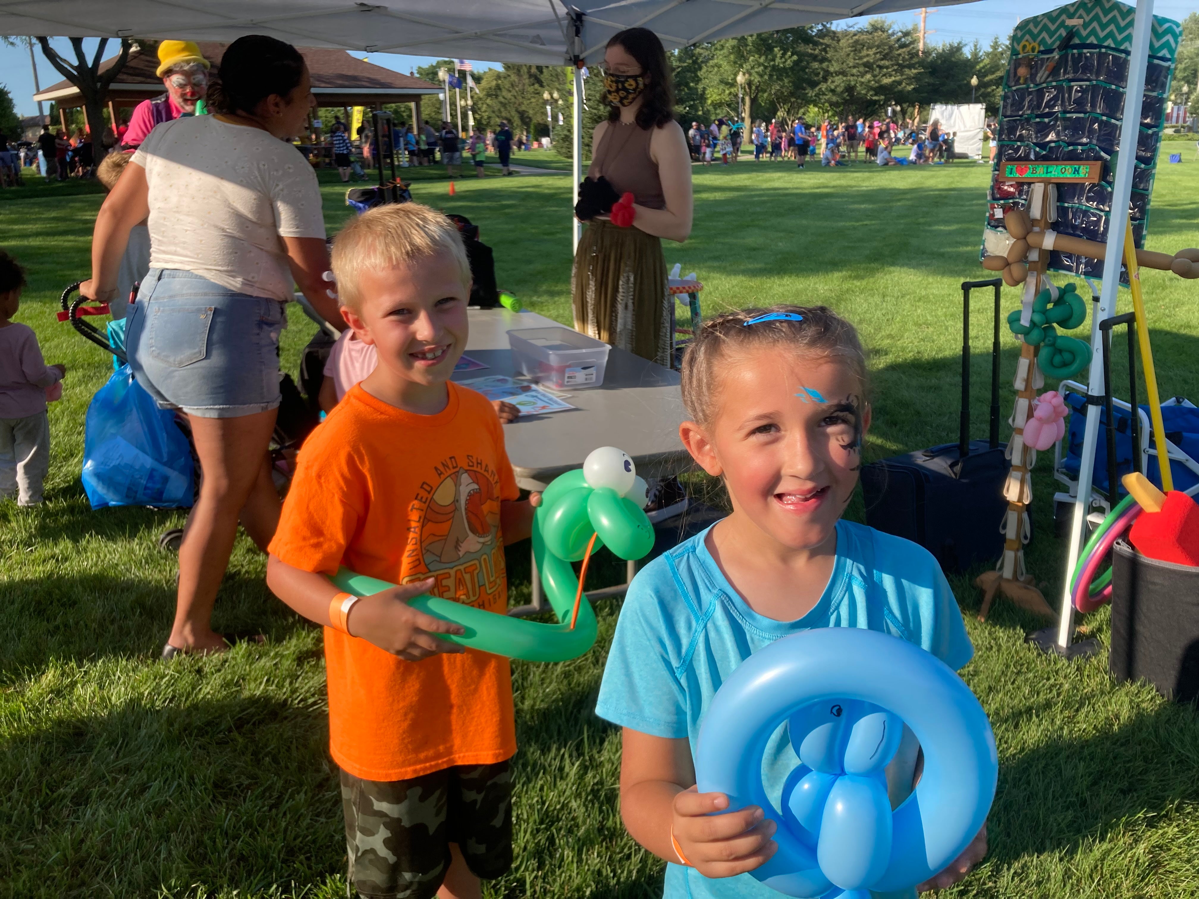 Two children at the 2022 Family Carnival with balloon art