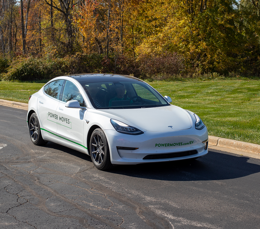 A KREMC member drives an electric vehicle drives through the parking lot at the 2022 EV Test Drive Experience