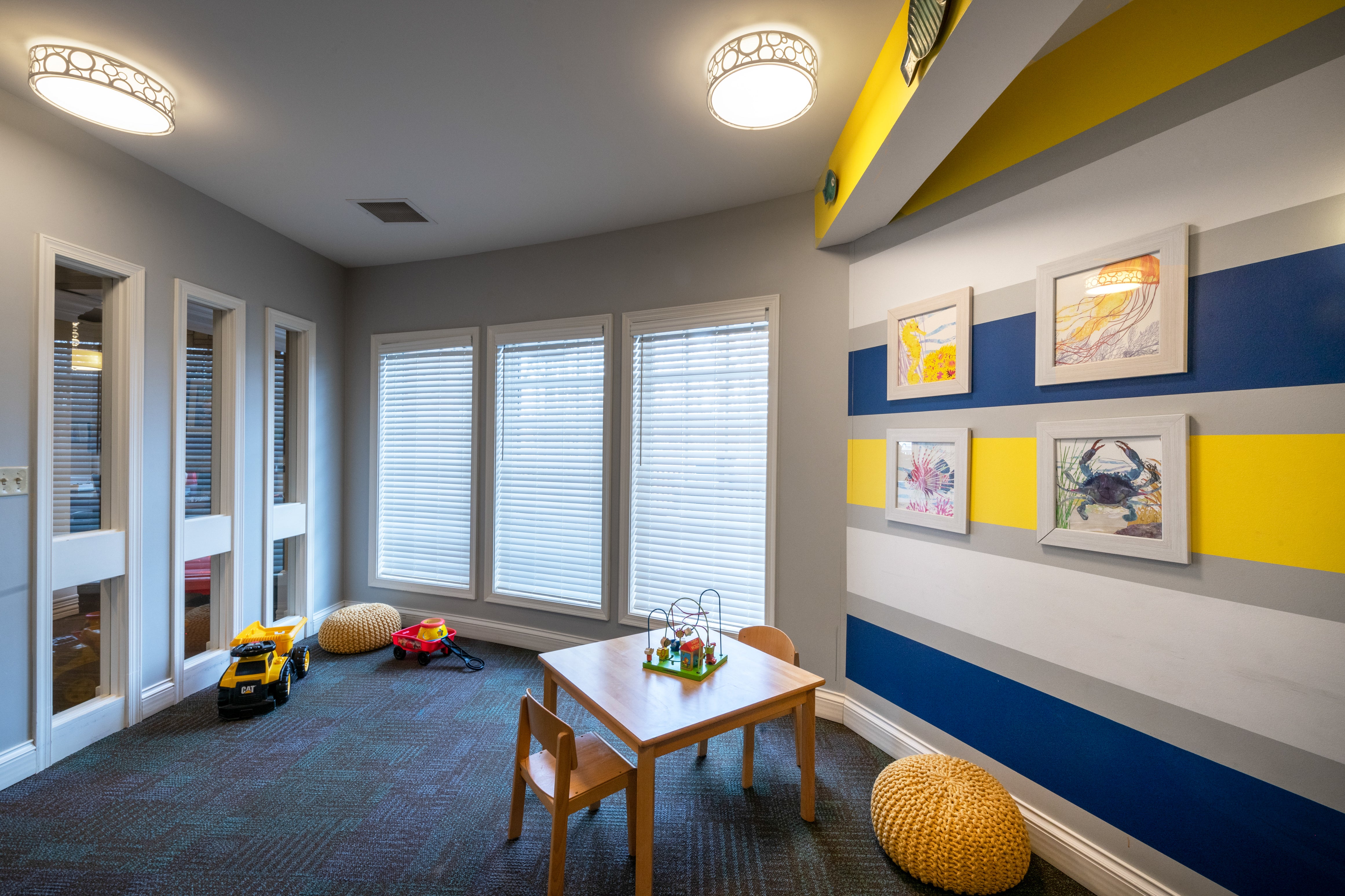 A blue and yellow play room in a Hope's Harbor house.