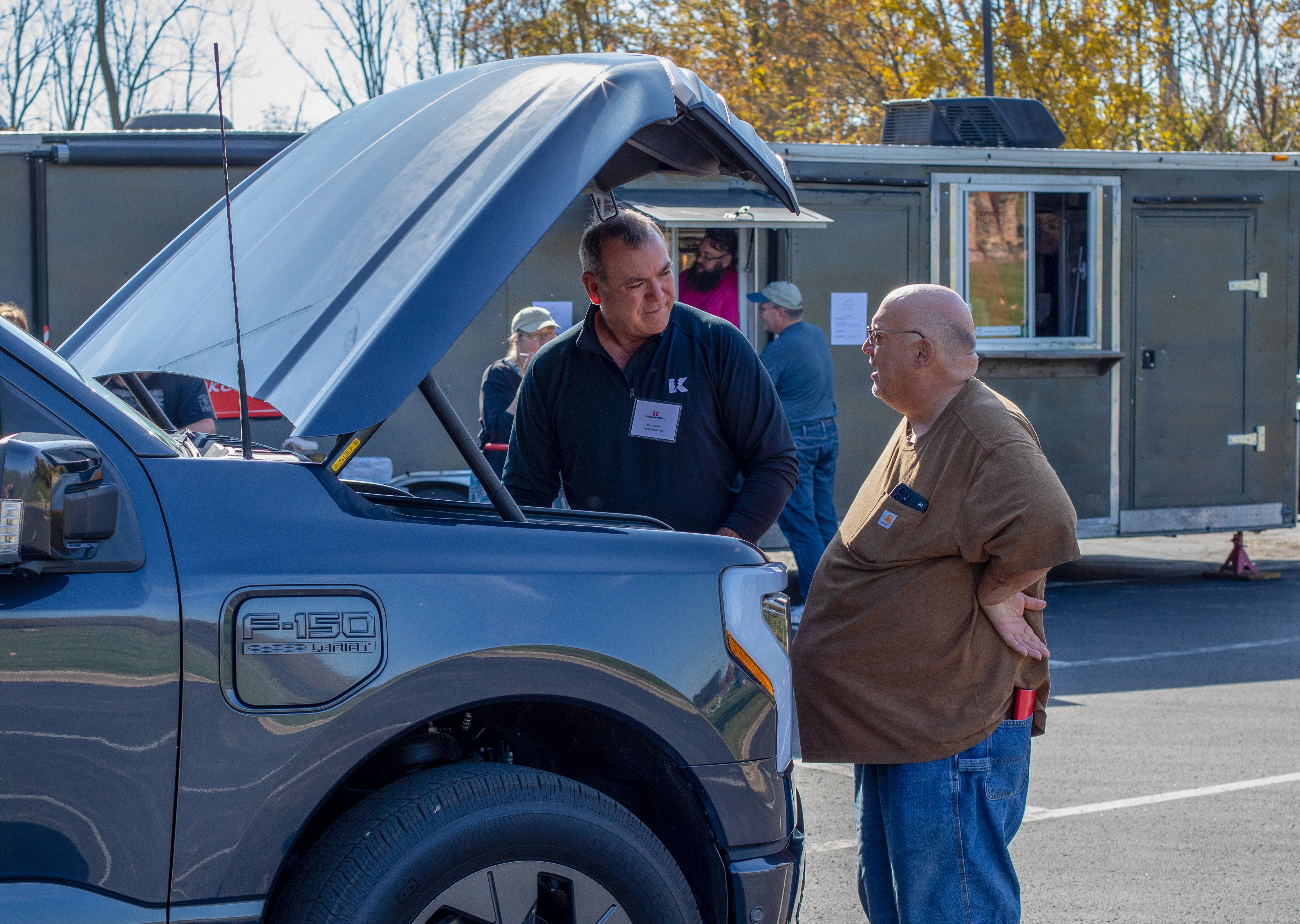 KREMC CEO Kurt Carver shows the inside of an EV to a member