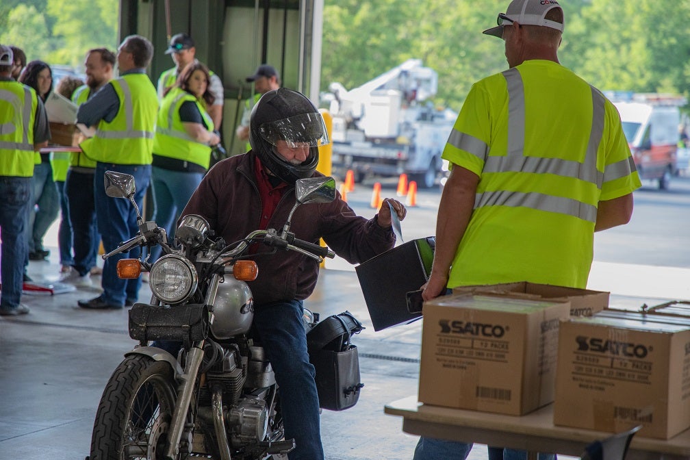 A KREMC member drives through the annual meeting on a motorcycle.
