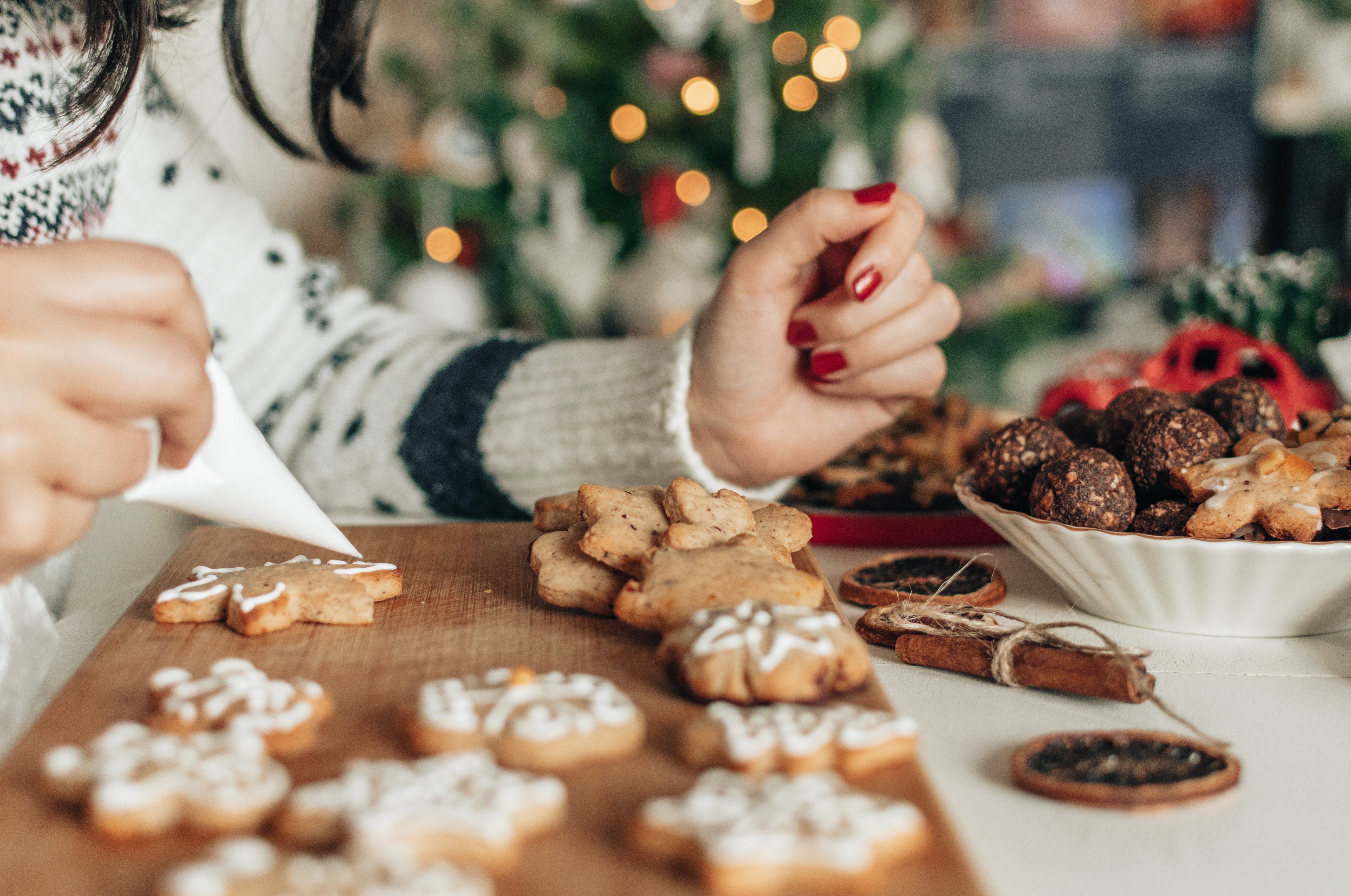 Hand decorating Christmas gingerbread cookies