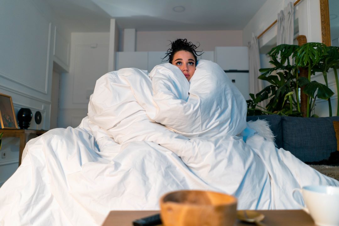 Woman buried in blankets