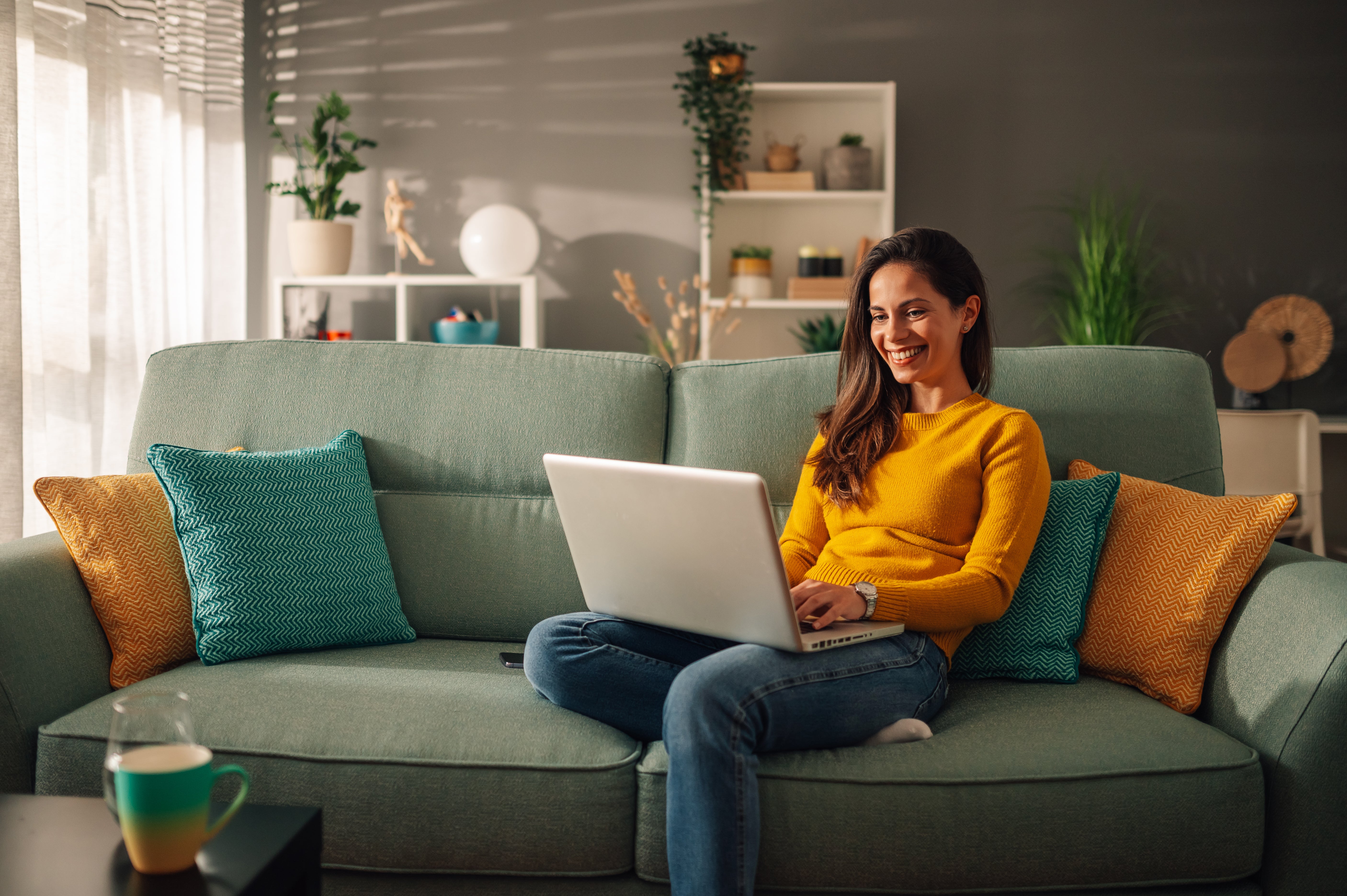 Woman sitting on couch with laptop