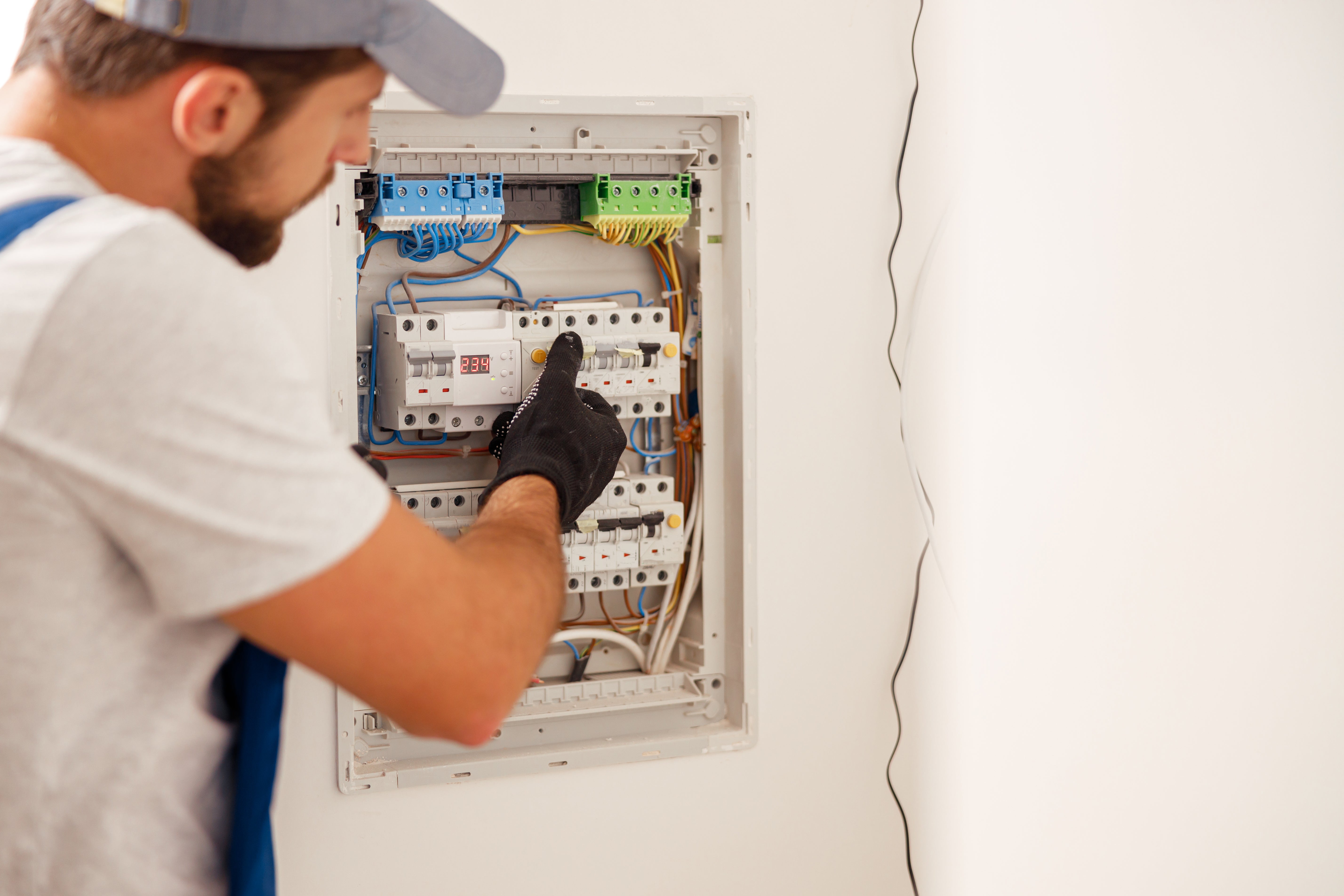 Man checking his home's electric fuses